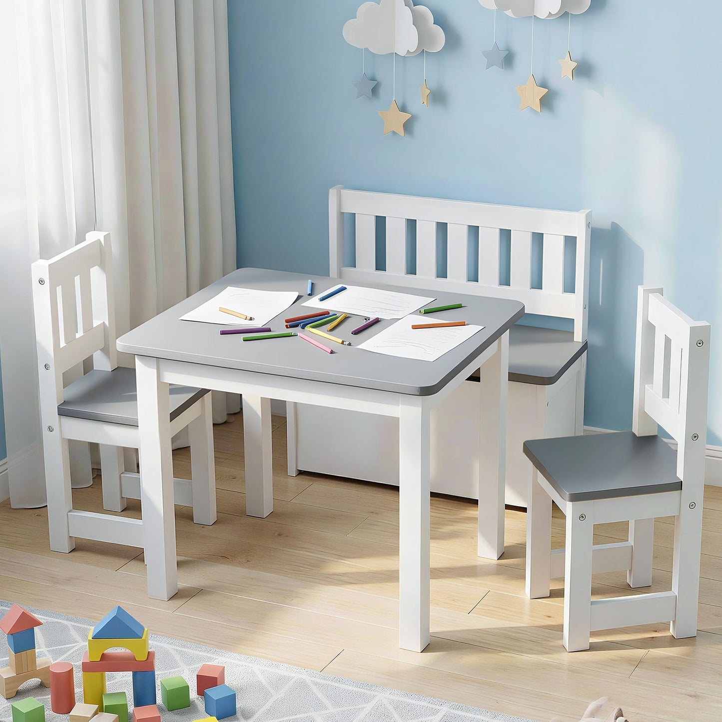 Children's play area with a white table and chairs against a blue wall.