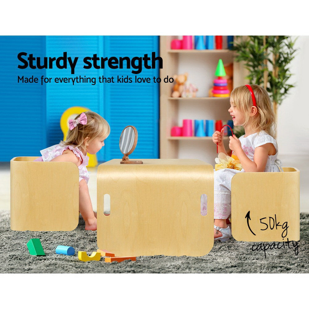 Children playing with wooden furniture in a room with toys and books.