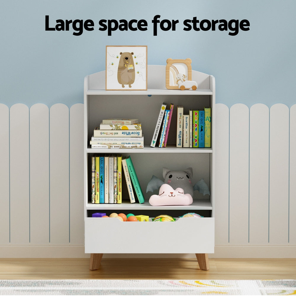 White bookshelf with books and toys against a light blue wall.