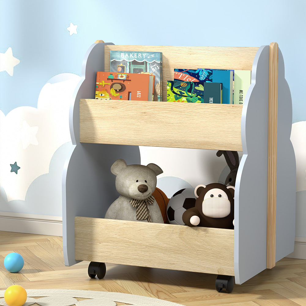 Children's bookshelf with books and toys against a cloud-themed wall.