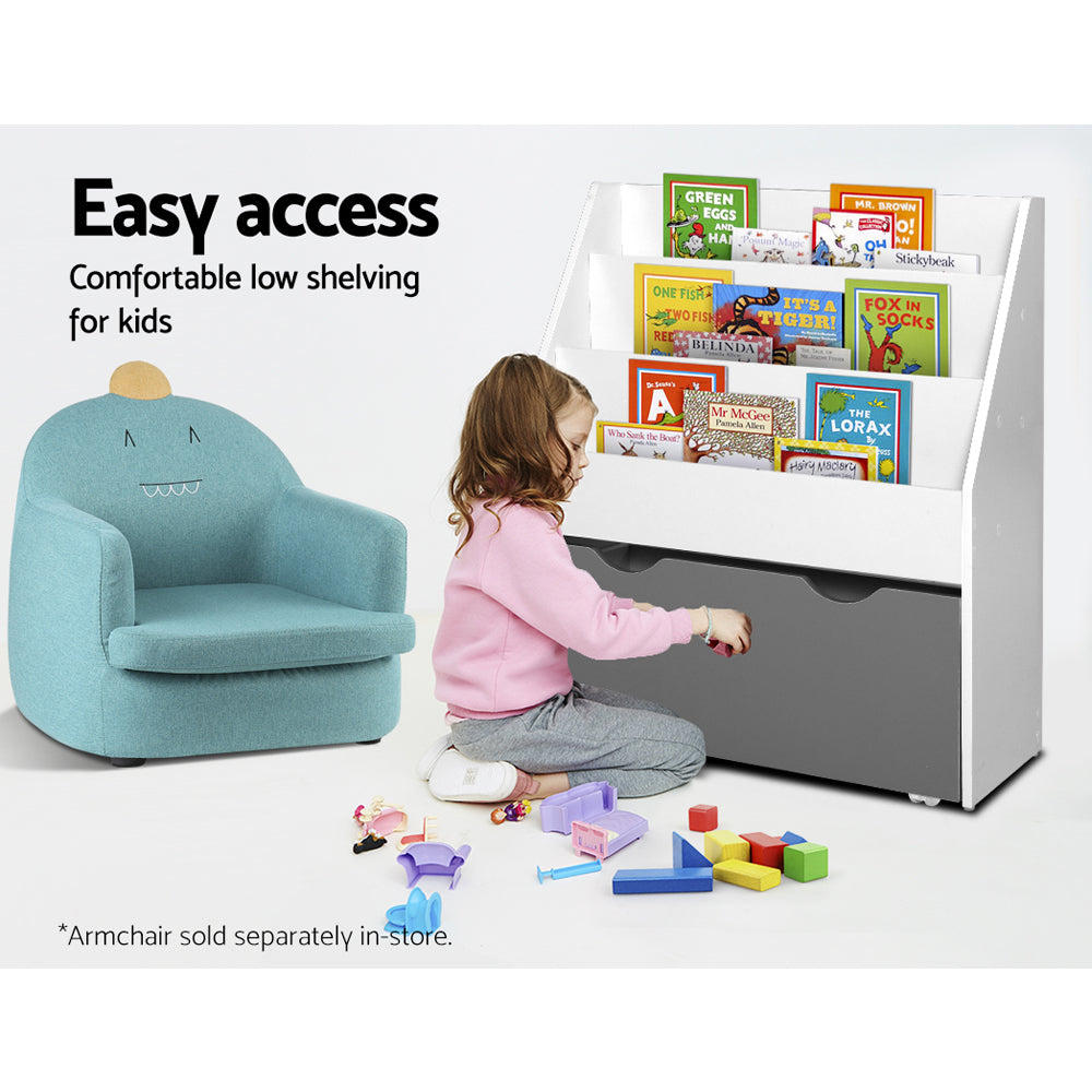 Child playing with toys near a low shelving unit with books on a white background
