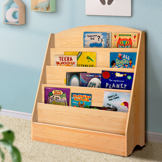 Wooden bookshelf with children's books against a light blue wall.