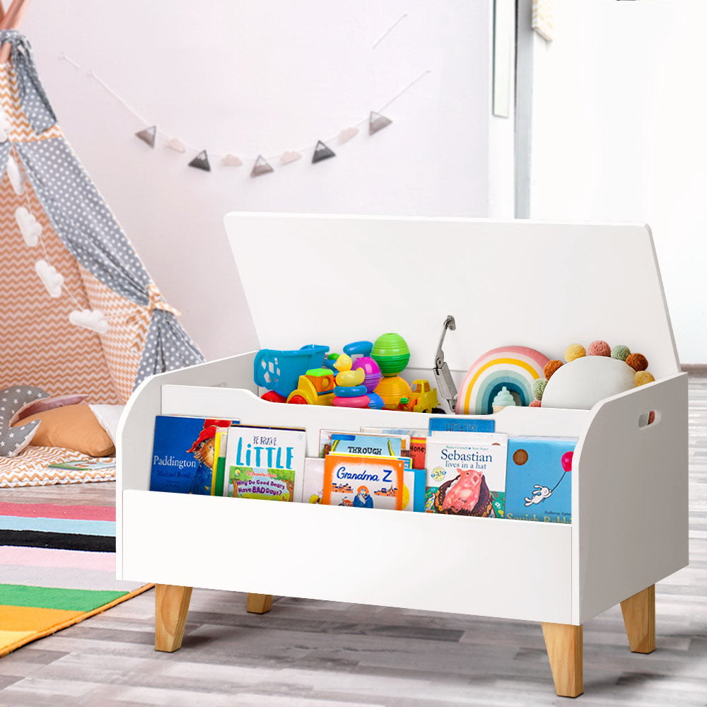 White toy storage bench with books and toys in a child's room