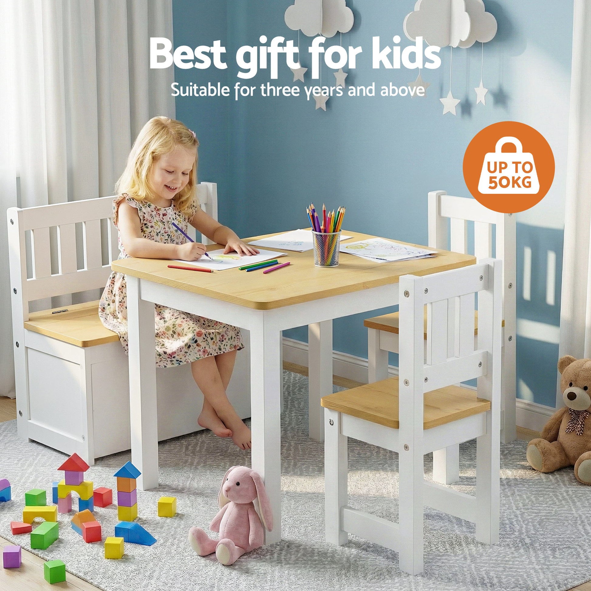 Children's table and chairs set with a child sitting at the table, surrounded by toys in a room.
