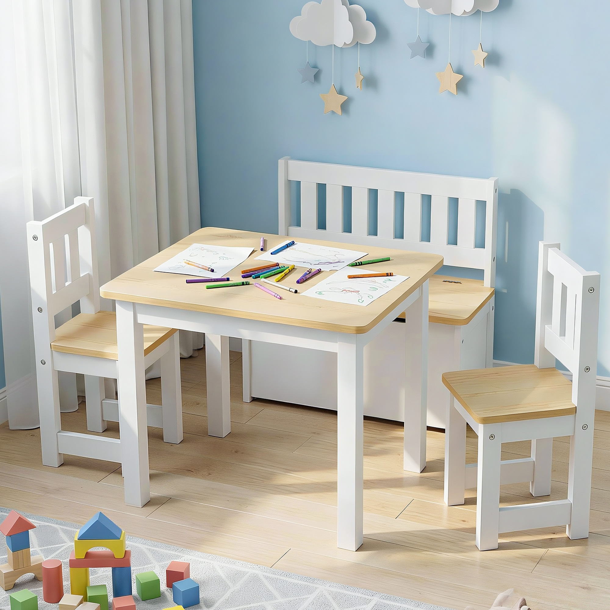 Children's table and chairs set with coloring materials in a room with light blue walls and wooden floor.