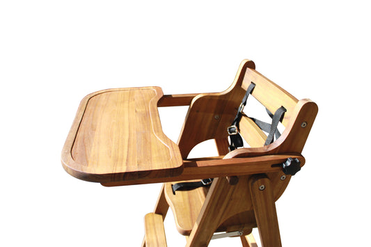 Wooden high chair with tray on a white background