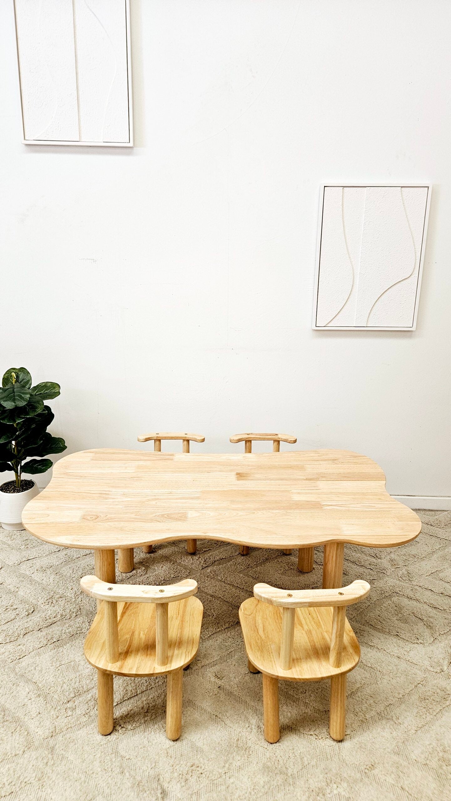 Wooden dining table with chairs in a minimalistic room.